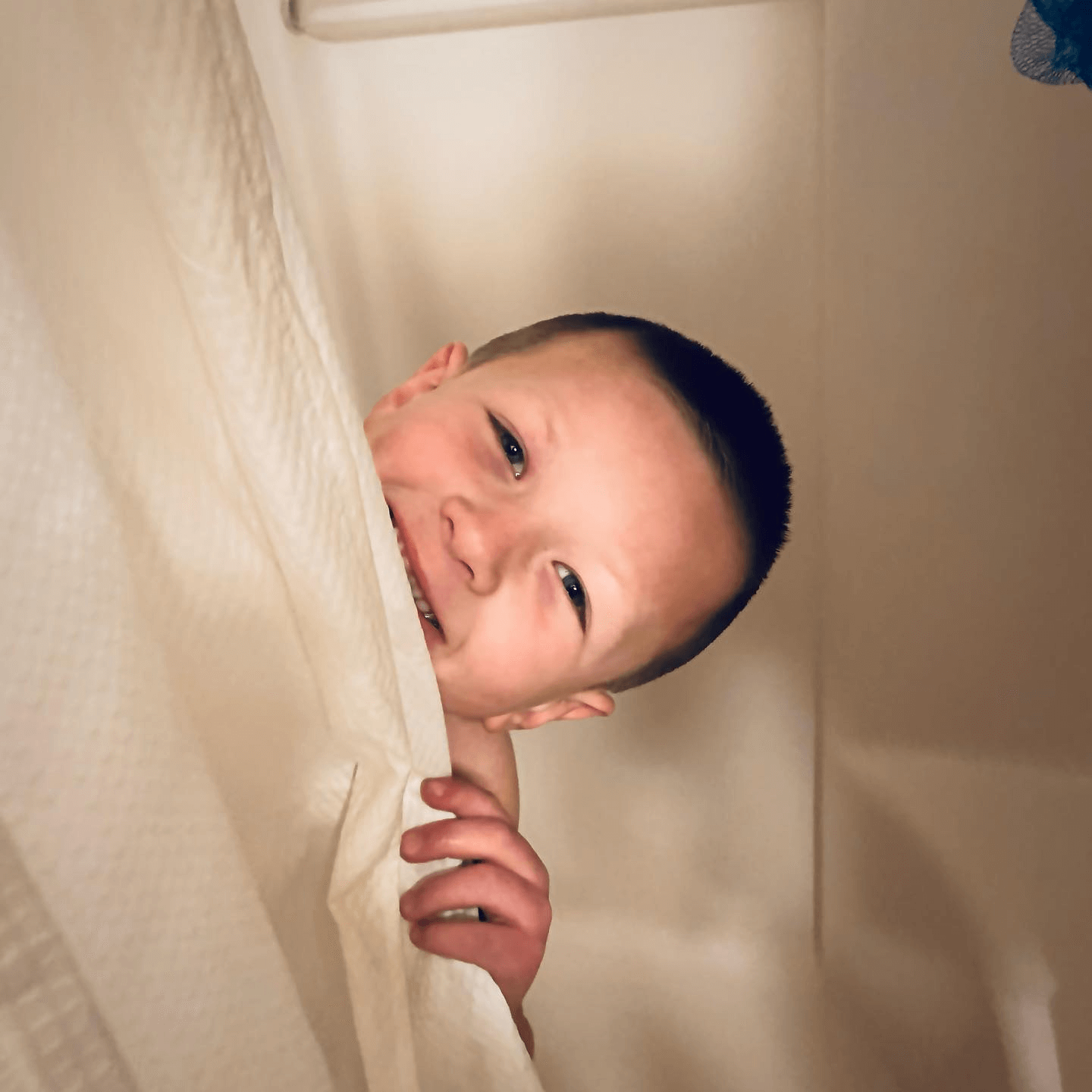 Isaac peeking around the shower curtain...they don't stay little very long.